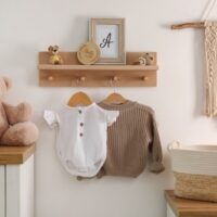 Wooden,Shelf,With,Baby,Clothes,,Toys,And,Furniture,In,Room.